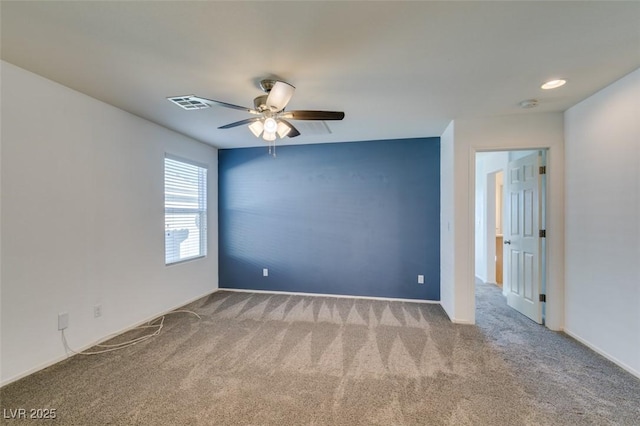 unfurnished room with light colored carpet and ceiling fan