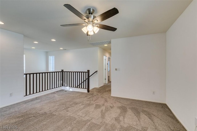 spare room featuring light colored carpet