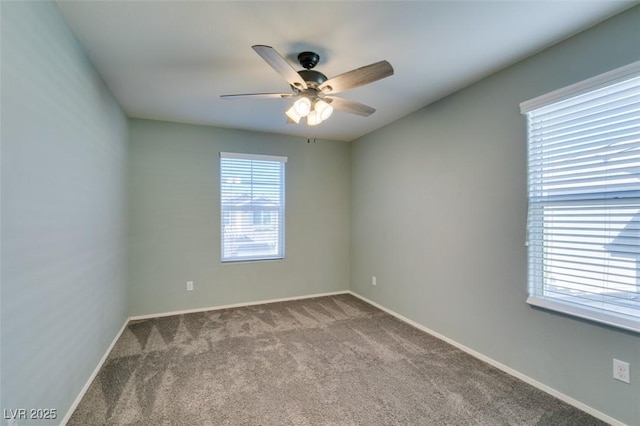 carpeted empty room featuring a healthy amount of sunlight and ceiling fan