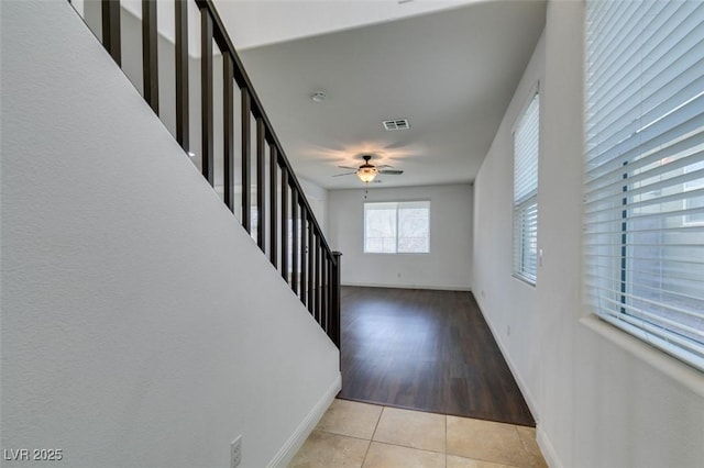 tiled entryway featuring ceiling fan