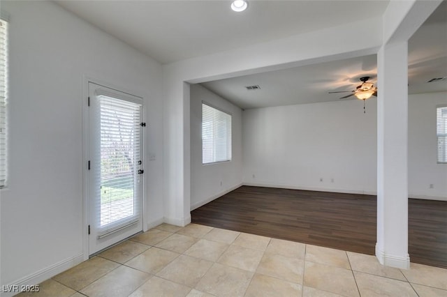 interior space with ceiling fan and light tile patterned flooring