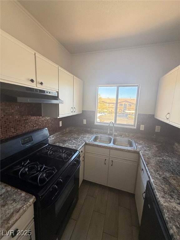 kitchen featuring dark wood-type flooring, sink, crown molding, black appliances, and white cabinets