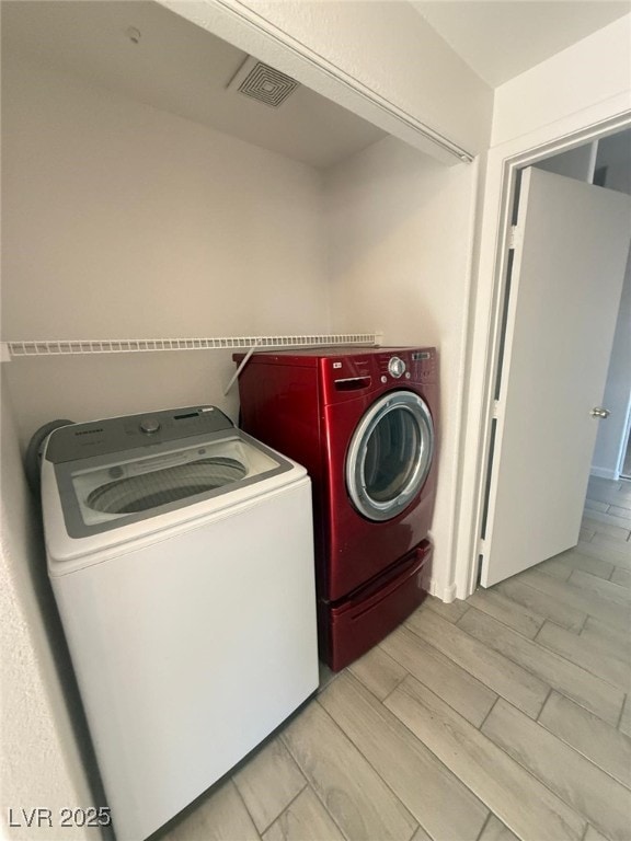 washroom with washing machine and clothes dryer