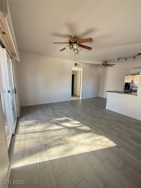 unfurnished living room with light hardwood / wood-style floors and ceiling fan