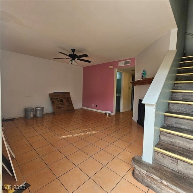 unfurnished living room with light tile patterned floors and ceiling fan