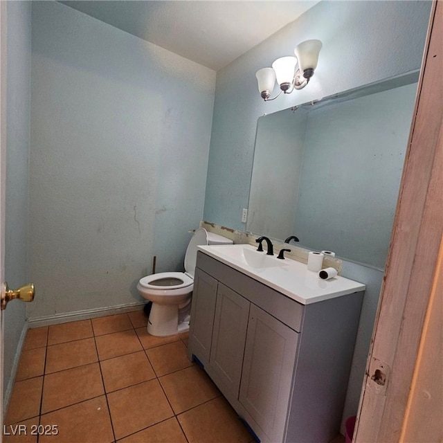 bathroom featuring vanity, tile patterned floors, and toilet