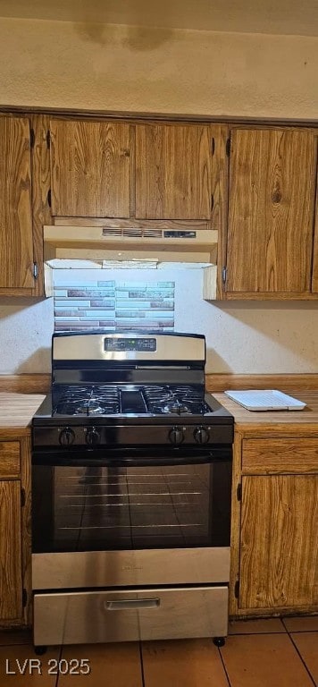 kitchen with light tile patterned flooring and gas stove