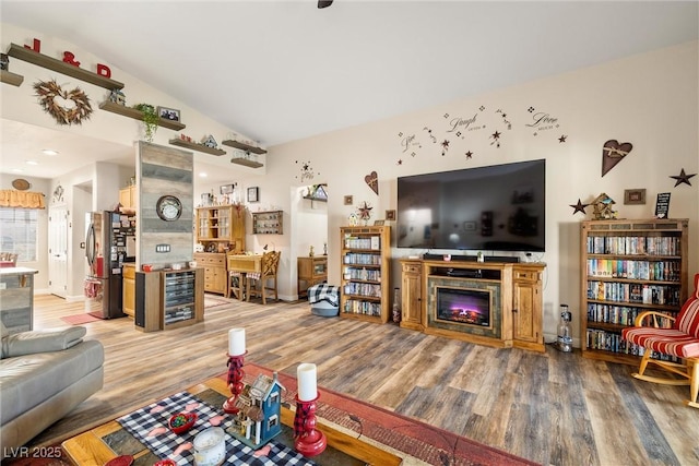 living room with lofted ceiling and hardwood / wood-style floors