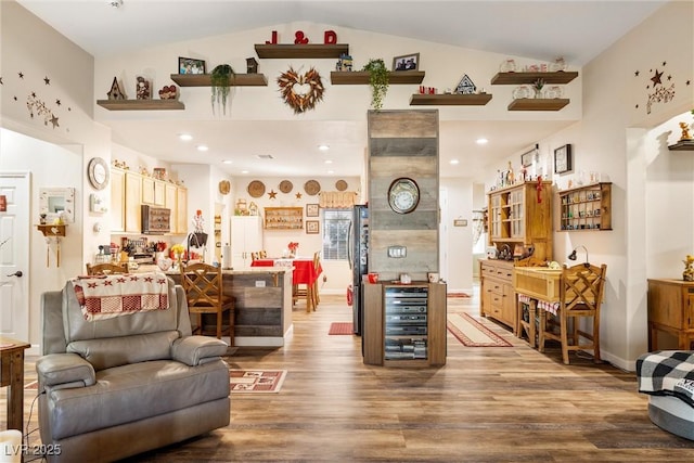 living room with lofted ceiling, hardwood / wood-style floors, and beverage cooler