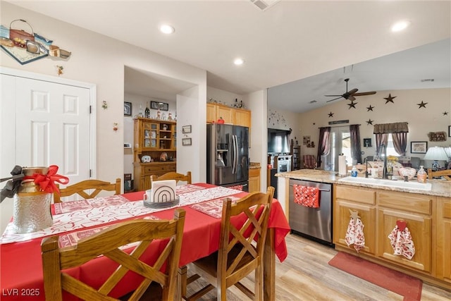 kitchen with lofted ceiling, sink, ceiling fan, appliances with stainless steel finishes, and light wood-type flooring