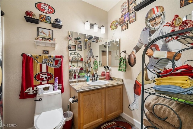 bathroom with vanity and toilet