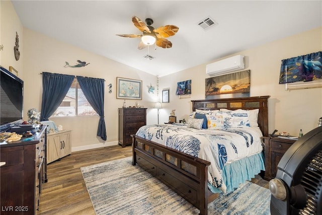 bedroom featuring hardwood / wood-style flooring, ceiling fan, lofted ceiling, and an AC wall unit