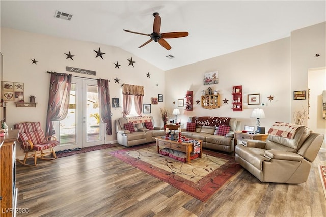 living room with vaulted ceiling, hardwood / wood-style floors, ceiling fan, and french doors