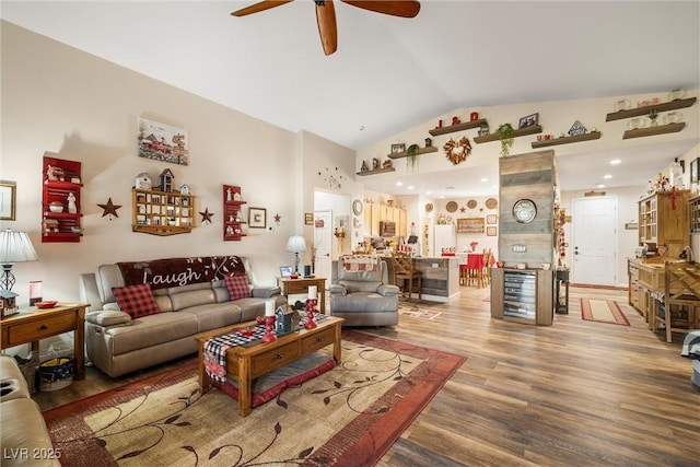 living room featuring hardwood / wood-style flooring, ceiling fan, and high vaulted ceiling