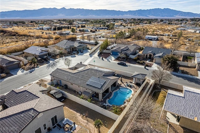 birds eye view of property with a mountain view