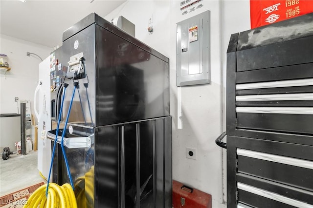 kitchen featuring concrete flooring, electric panel, and refrigerator