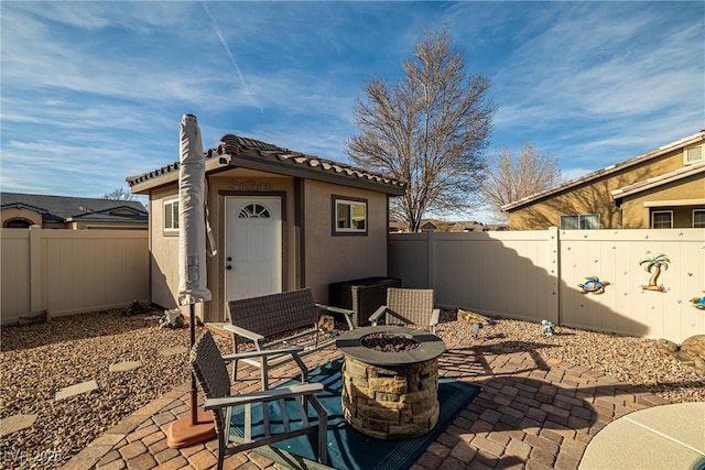 view of patio / terrace featuring a storage shed and a fire pit