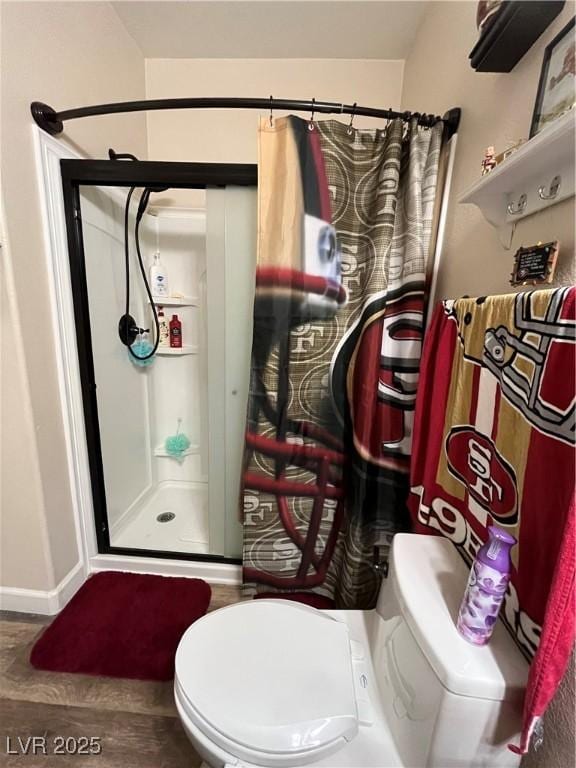 bathroom featuring wood-type flooring, toilet, and walk in shower