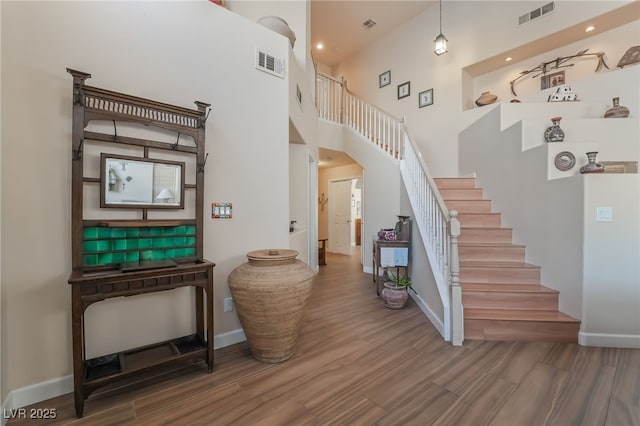 stairway featuring a high ceiling