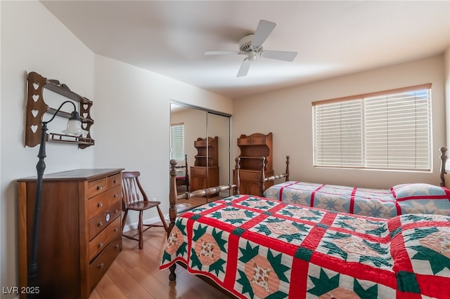 bedroom with light hardwood / wood-style floors, a closet, and ceiling fan