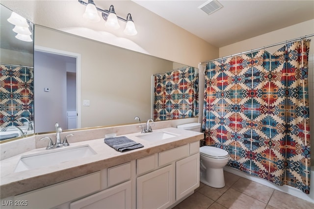 bathroom with vanity, tile patterned floors, and toilet