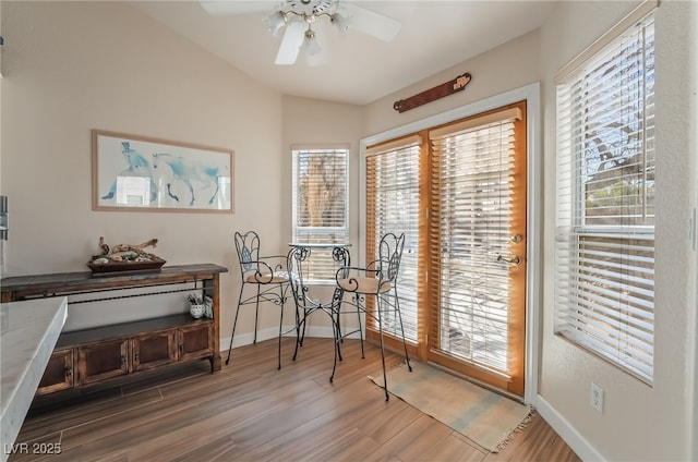 dining area with ceiling fan and wood-type flooring