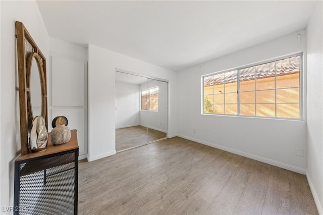 empty room with light hardwood / wood-style flooring