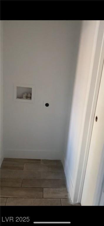 washroom with hardwood / wood-style flooring and washer hookup