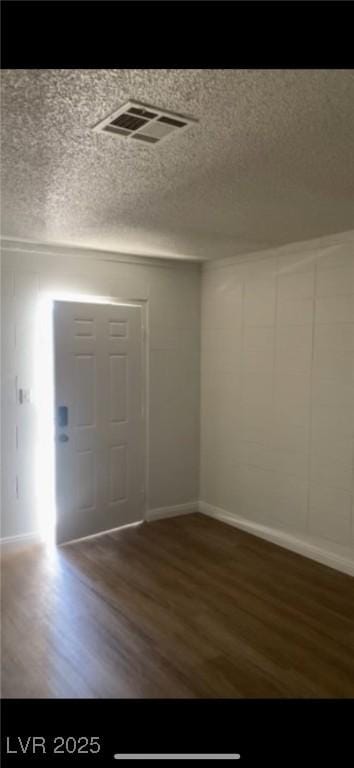 entryway with dark hardwood / wood-style flooring