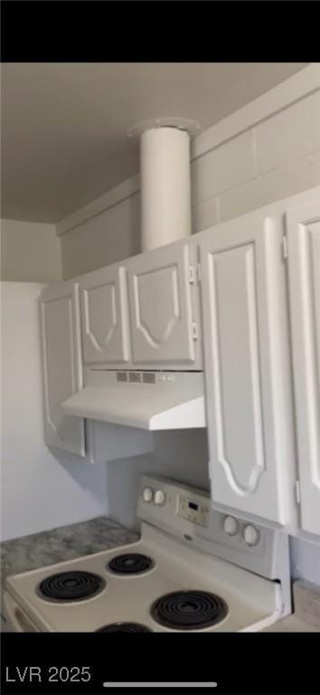 interior details with white electric stove and white cabinets