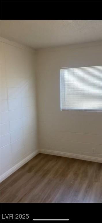 spare room with hardwood / wood-style flooring