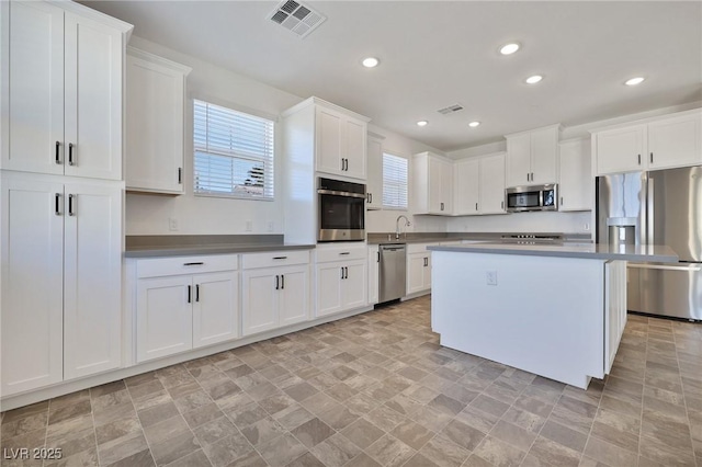 kitchen featuring a center island, white cabinets, and appliances with stainless steel finishes