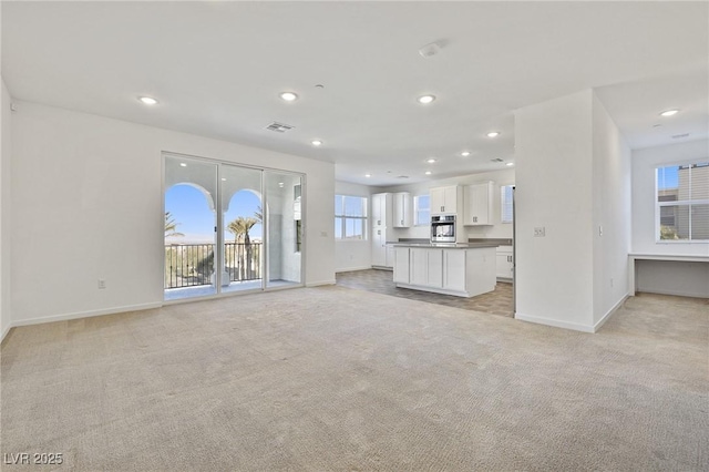 unfurnished living room with light carpet