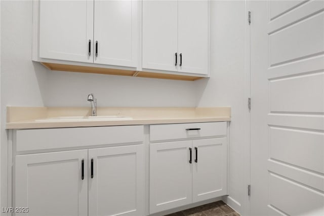 bar with sink and white cabinets