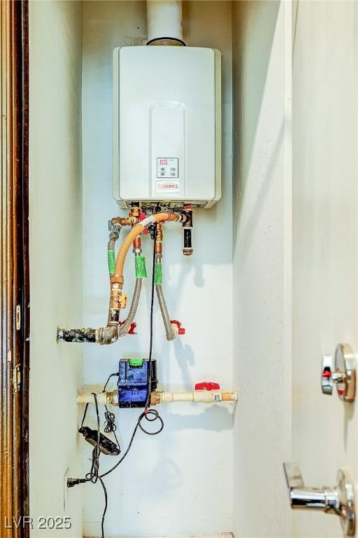 utility room featuring tankless water heater