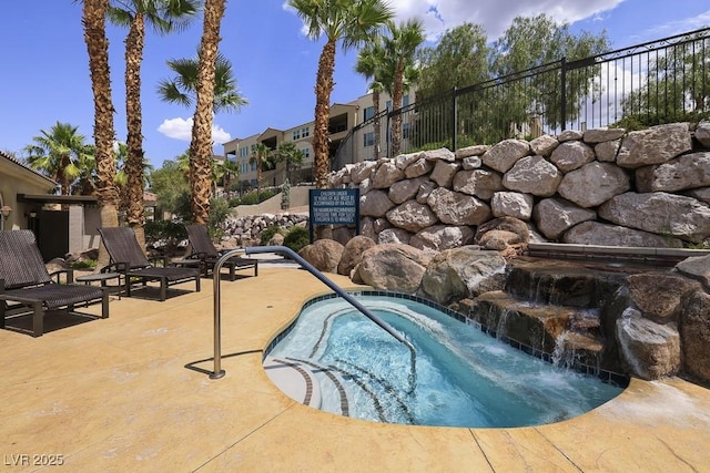 view of pool featuring a patio area and a hot tub