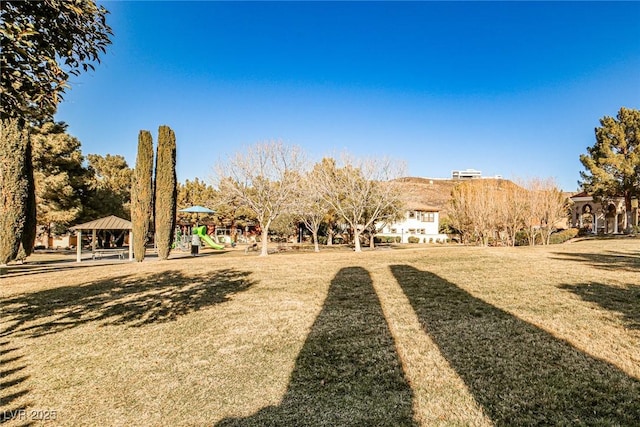 view of yard featuring a gazebo and a playground