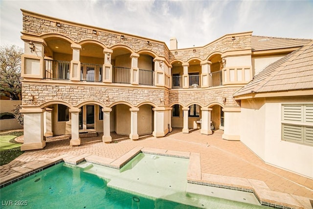 exterior space with a hot tub and a patio