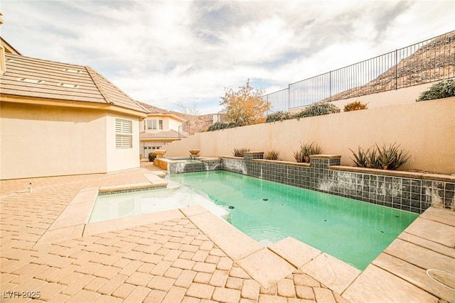 view of swimming pool featuring a hot tub, a patio, and pool water feature