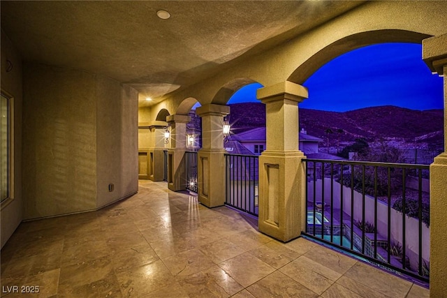 view of patio featuring a balcony and a mountain view