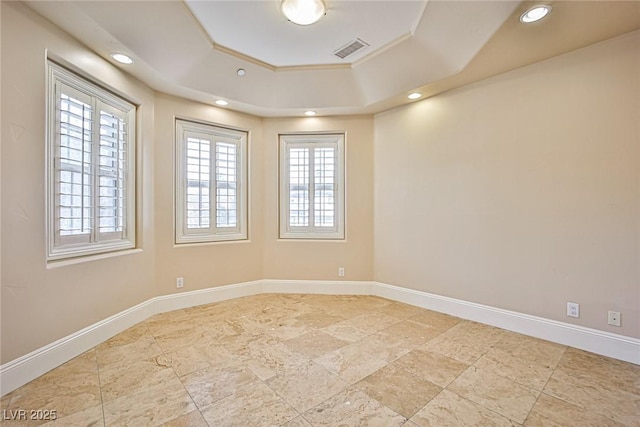 spare room featuring a tray ceiling