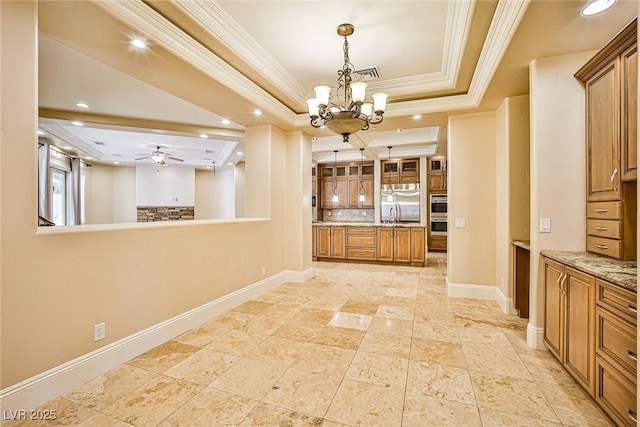 interior space with a notable chandelier, ornamental molding, and a raised ceiling