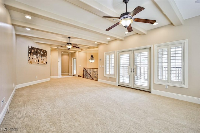 unfurnished living room featuring light carpet, beam ceiling, and french doors