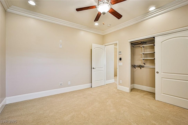 unfurnished bedroom with crown molding, a closet, ceiling fan, and light carpet