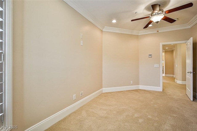 empty room with ornamental molding, light carpet, and ceiling fan