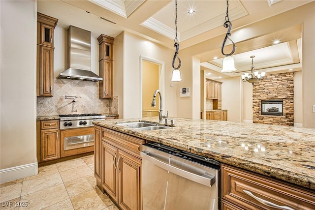 kitchen with sink, backsplash, hanging light fixtures, stainless steel appliances, and wall chimney exhaust hood