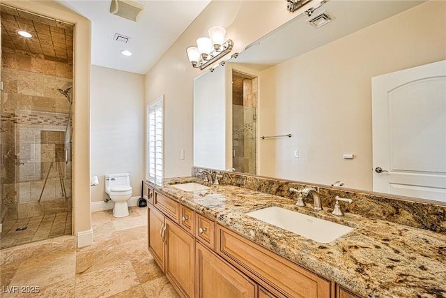 bathroom with vanity, toilet, and a shower with door