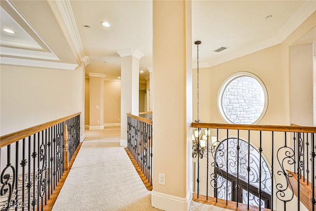 hallway featuring crown molding and ornate columns