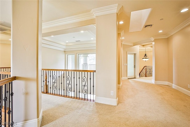 hallway with ornamental molding and carpet flooring