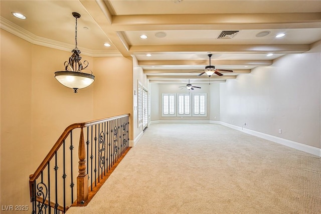 empty room featuring ceiling fan, carpet flooring, and beam ceiling